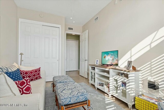 sitting room featuring wood finished floors and visible vents