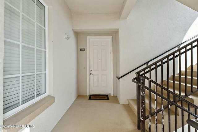 doorway to property featuring stucco siding