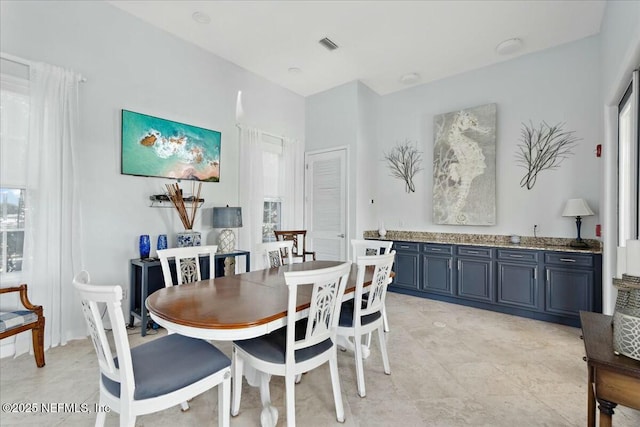 dining room featuring visible vents