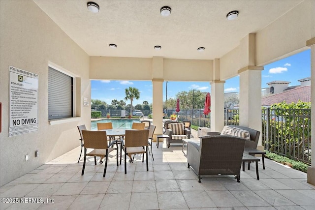 view of patio / terrace with an outdoor living space and fence