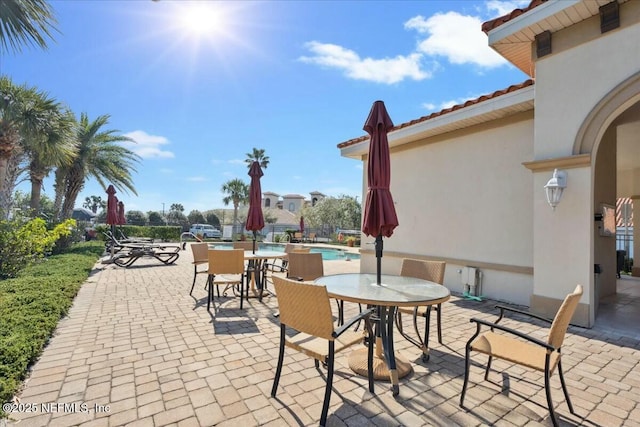 view of patio / terrace with outdoor dining area and a community pool