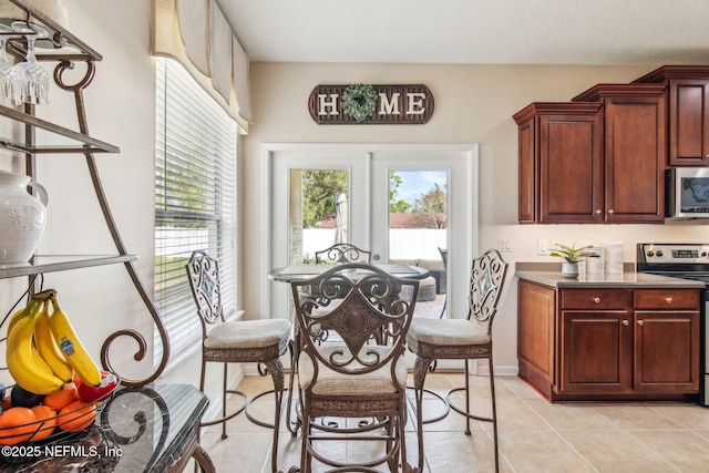 dining space with light tile patterned floors and baseboards