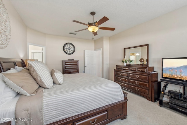 bedroom featuring light carpet, visible vents, and a ceiling fan