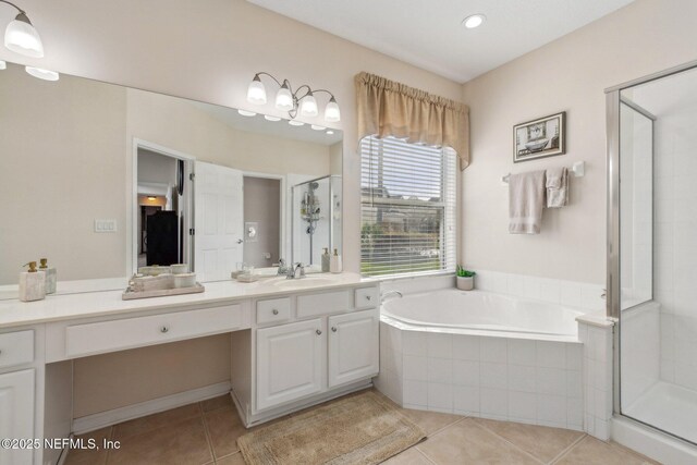 full bath with a stall shower, vanity, a bath, and tile patterned floors