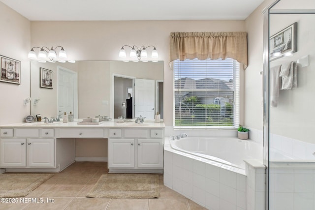 full bath with plenty of natural light, a sink, a bath, and tile patterned floors