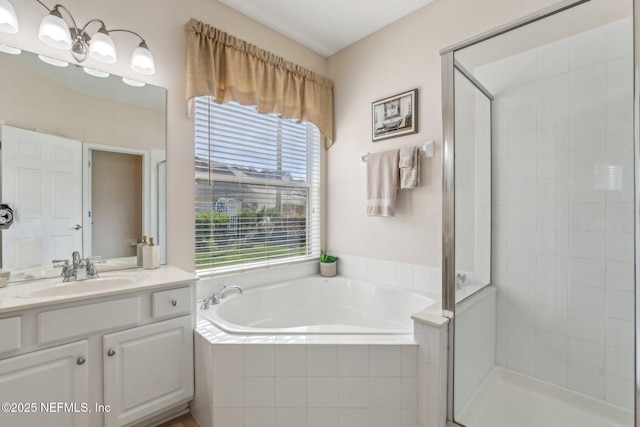 full bath featuring a stall shower, a garden tub, and vanity