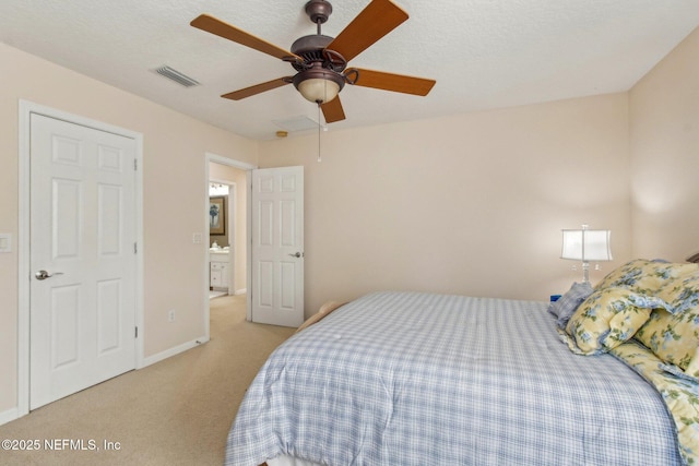 bedroom featuring visible vents, a ceiling fan, light carpet, a textured ceiling, and baseboards