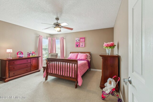 carpeted bedroom featuring ceiling fan, baseboards, and a textured ceiling