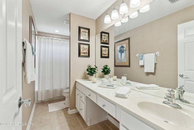 bathroom with tile patterned flooring, baseboards, vanity, and toilet