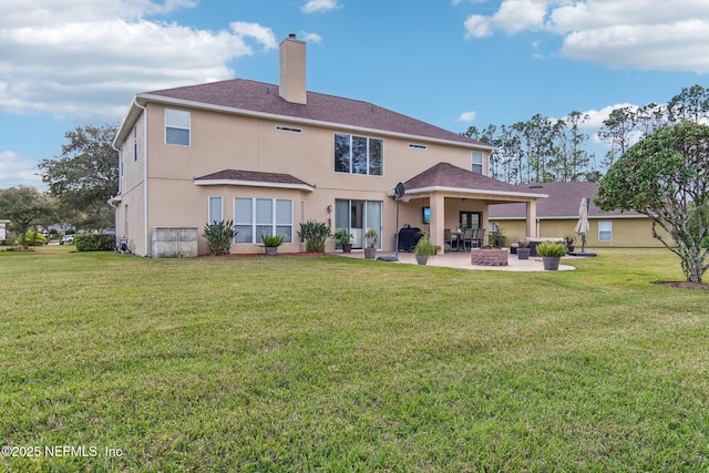 back of property featuring a yard, a patio, and stucco siding