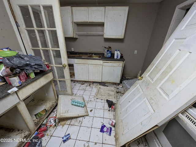 kitchen with white cabinets, dishwasher, and a sink