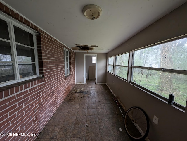 unfurnished sunroom with lofted ceiling