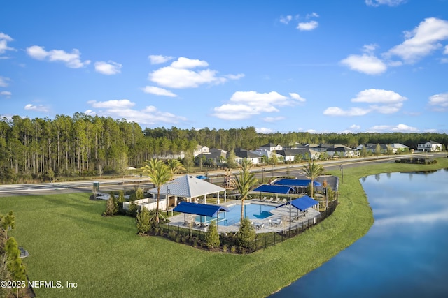 view of pool featuring a yard, a water view, and a residential view