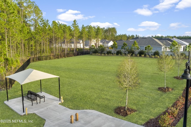 surrounding community with a yard, a patio, fence, and a residential view