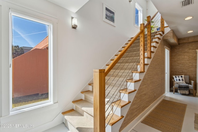 stairs featuring a healthy amount of sunlight, visible vents, and recessed lighting