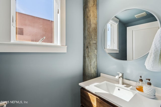 bathroom with a healthy amount of sunlight, visible vents, and vanity