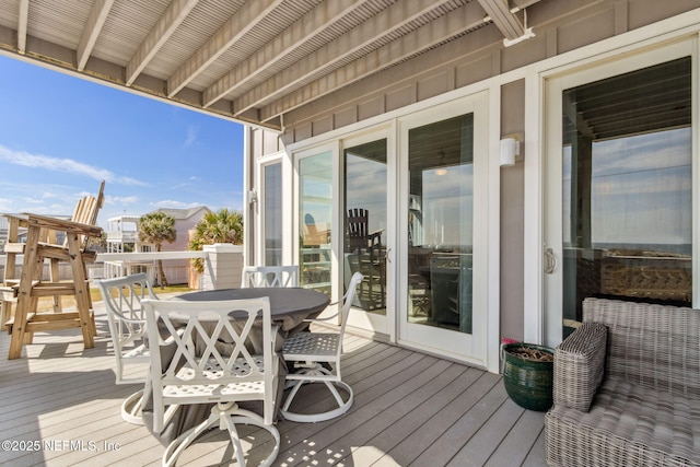 wooden terrace featuring outdoor dining space