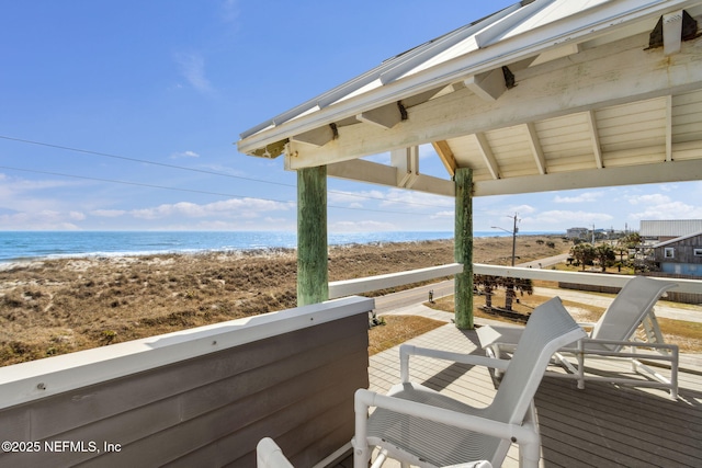 wooden terrace featuring a water view