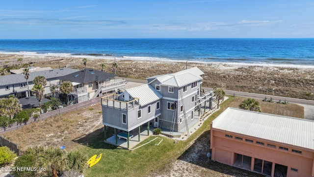 birds eye view of property featuring a water view and a beach view