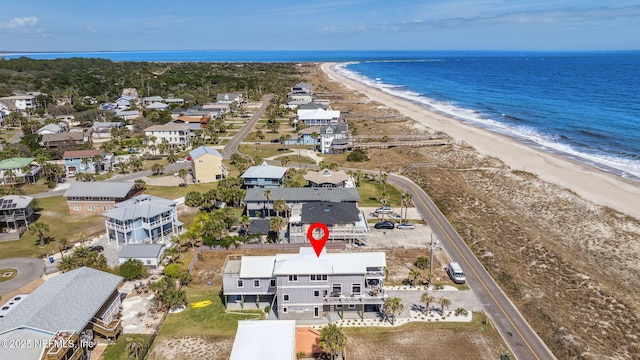 birds eye view of property featuring a water view and a view of the beach