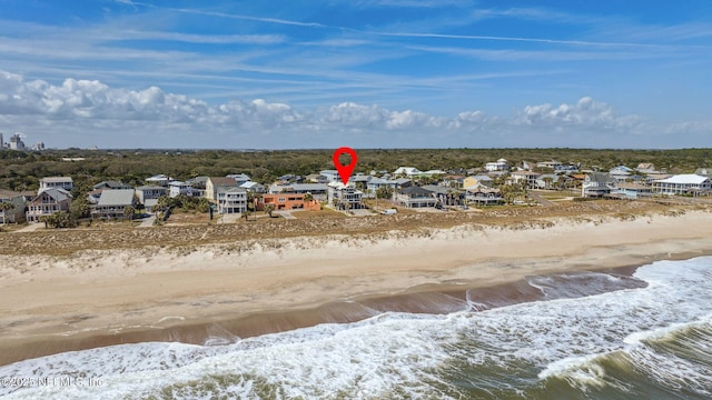 drone / aerial view featuring a residential view and a beach view