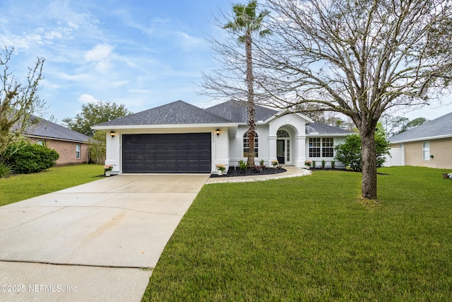 view of front of home featuring a garage, a front yard, driveway, and stucco siding