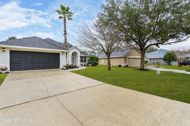 single story home featuring an attached garage, a shingled roof, concrete driveway, stucco siding, and a front lawn