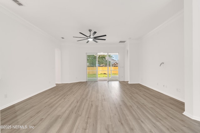 spare room with ornamental molding, baseboards, visible vents, and light wood finished floors