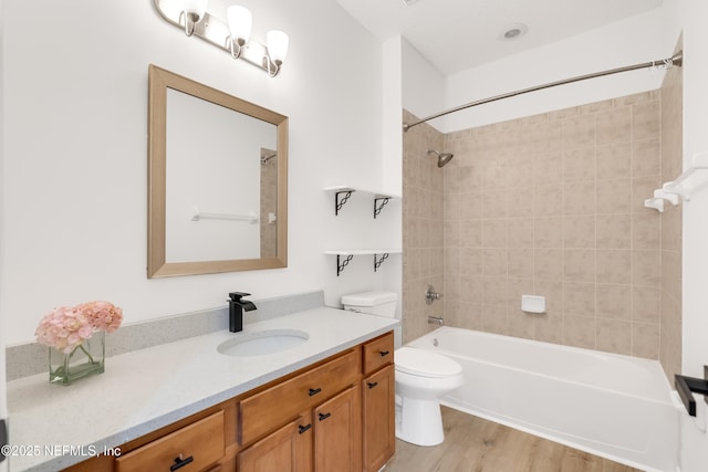 full bath with shower / washtub combination, vanity, toilet, and wood finished floors