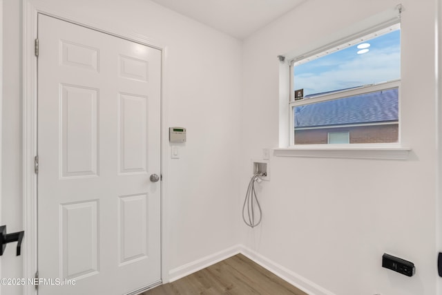 laundry room featuring washer hookup, laundry area, baseboards, and wood finished floors