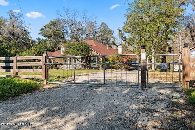 view of gate featuring fence