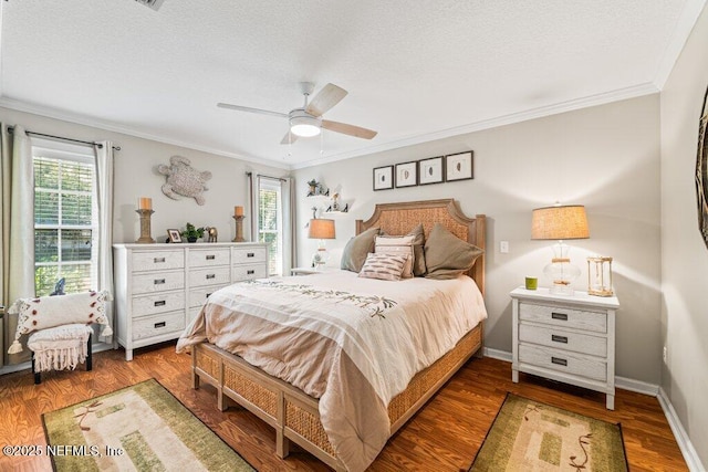 bedroom featuring multiple windows, baseboards, and wood finished floors