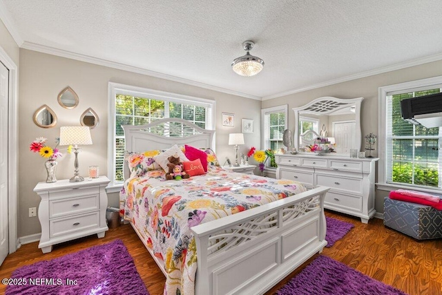 bedroom with baseboards, ornamental molding, dark wood finished floors, and a textured ceiling