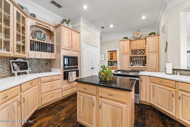 kitchen with visible vents, backsplash, built in microwave, light brown cabinetry, and gas range