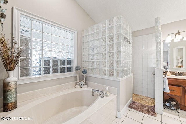 full bathroom featuring a garden tub, vanity, walk in shower, and tile patterned floors