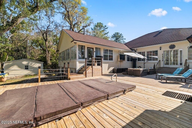 wooden deck featuring outdoor lounge area and a sunroom