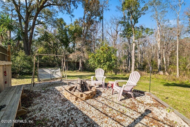 view of yard with a fire pit