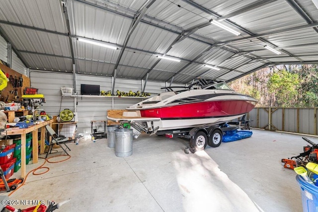 garage with a carport and fence