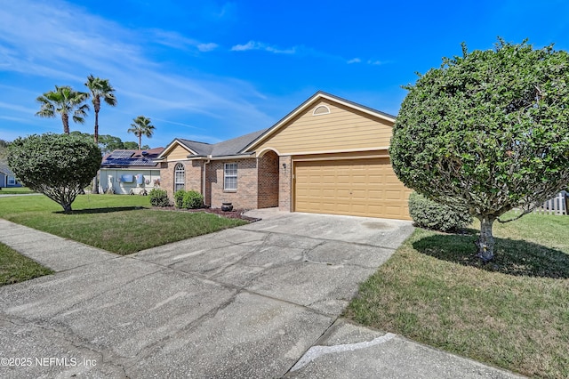 ranch-style home featuring brick siding, roof mounted solar panels, a garage, driveway, and a front lawn