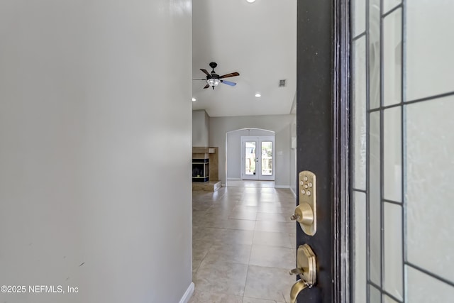 hall featuring french doors, light tile patterned flooring, visible vents, and baseboards