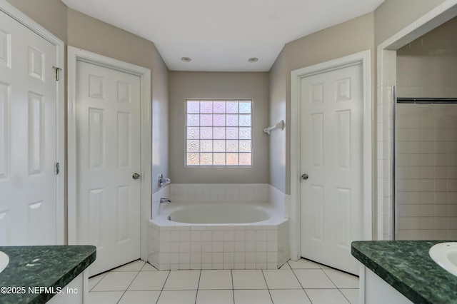 full bath with tile patterned flooring, vanity, and a bath