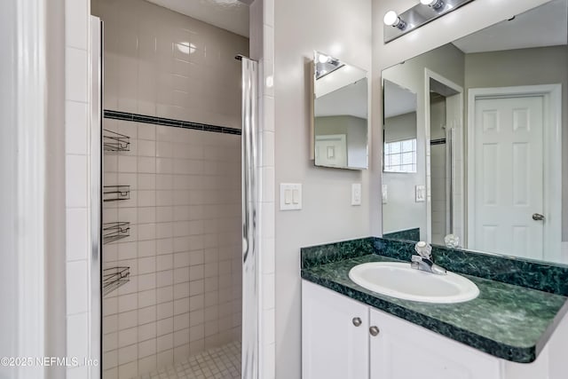 full bathroom with a shower stall and vanity