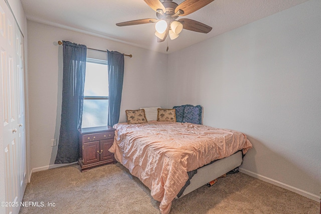 bedroom with a ceiling fan, light colored carpet, and baseboards