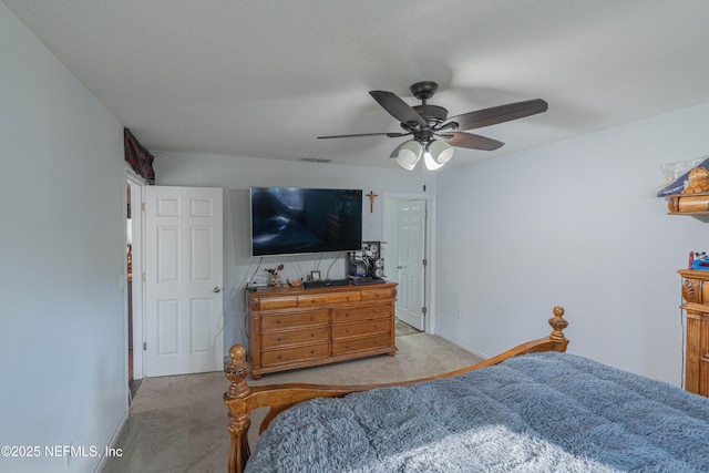 bedroom with carpet floors, visible vents, baseboards, and a ceiling fan