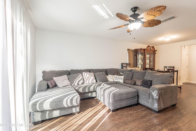 living area with a ceiling fan, dark wood-style flooring, and visible vents