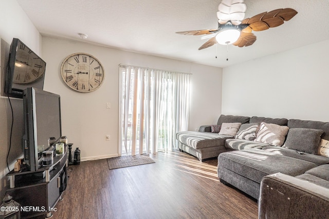 living area featuring ceiling fan, a textured ceiling, wood finished floors, and baseboards