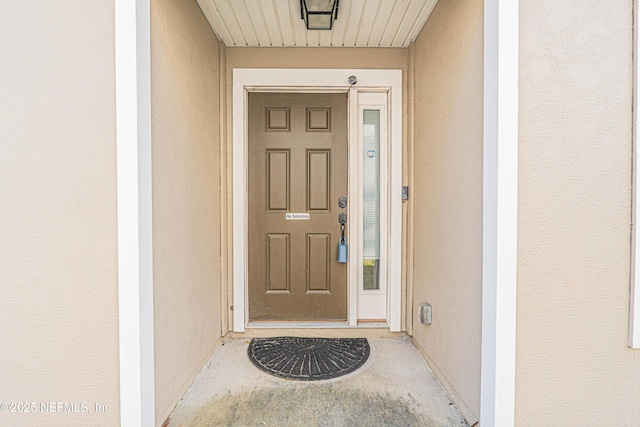 doorway to property with stucco siding