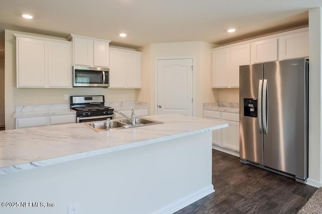 kitchen with stainless steel appliances, recessed lighting, a sink, and white cabinets