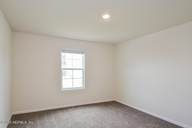 carpeted empty room featuring recessed lighting and baseboards