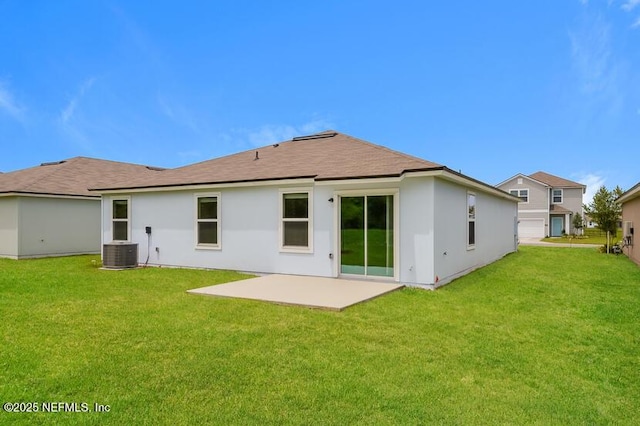 rear view of property with a patio area, central AC, a lawn, and stucco siding